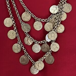 Coin necklace. Coins have design on both sides. Long chain with 3 gold chains.